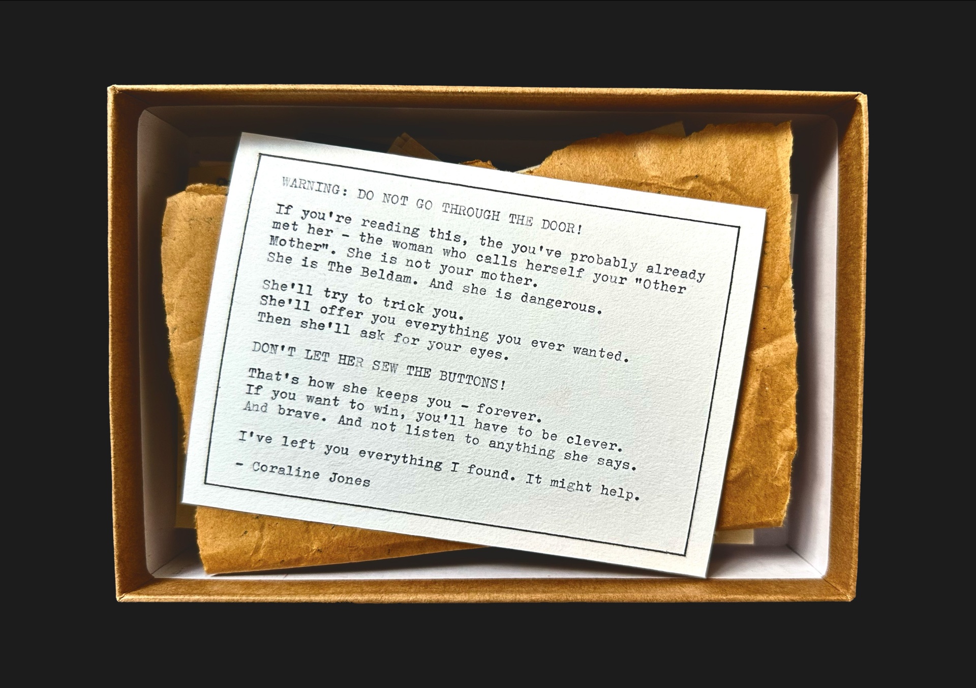 Coraline Found Objects — warning note in a kraft box